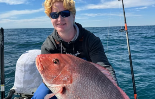 Captain Tim with Redfish 500x320